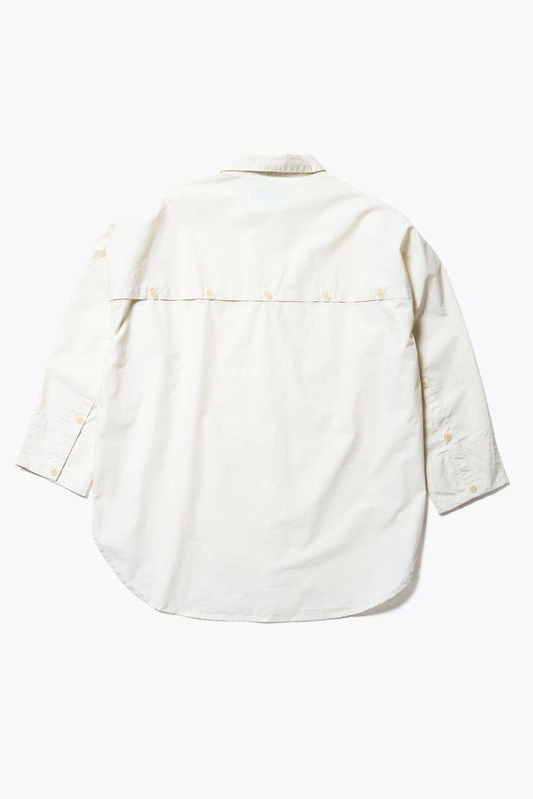 Flat Back of the Kestrel Shirt Ecru – relaxed long sleeve shirt with back button placket and scoop hemline, worn by model. Available in XXS, XS, S, M, L
