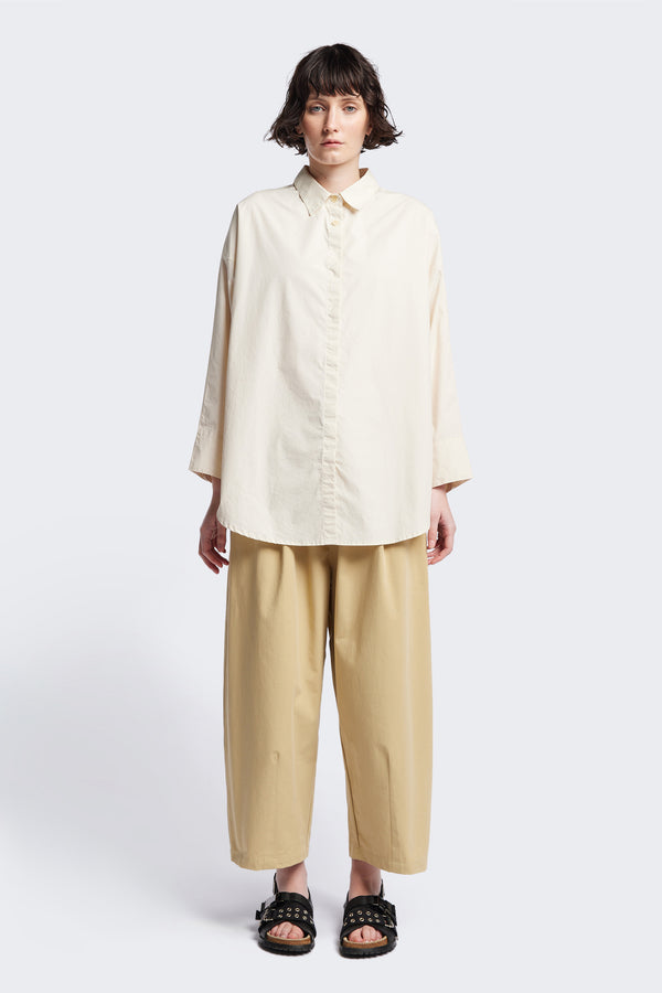 Kestrel Shirt Ecru – relaxed long sleeve shirt with back button placket and scoop hemline, worn by model. Available in XXS, XS, S, M, L