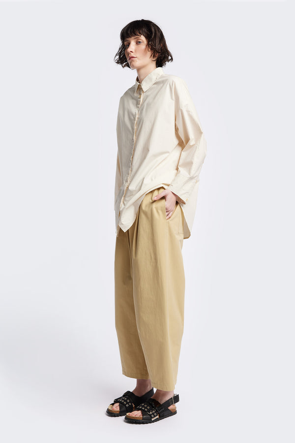 Kestrel Shirt Ecru – relaxed long sleeve shirt with back button placket and scoop hemline, worn by model. Available in XXS, XS, S, M, L