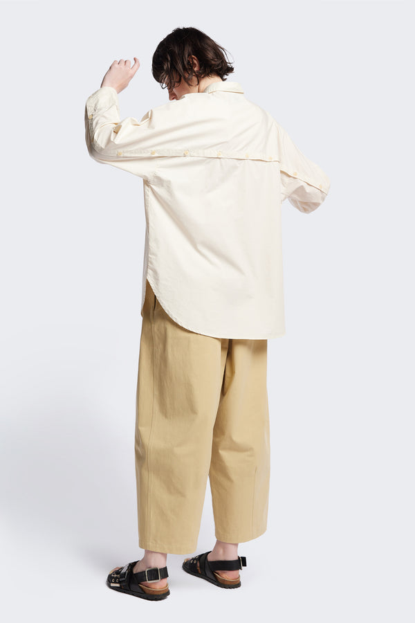 Back of the Kestrel Shirt Ecru – relaxed long sleeve shirt with back button placket and scoop hemline, worn by model. Available in XXS, XS, S, M, L
