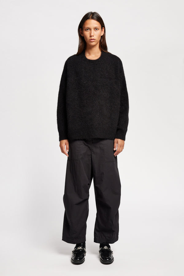 Front view of Model wearing alpaca blend Laurel Crew Neck Knit Sweater in black