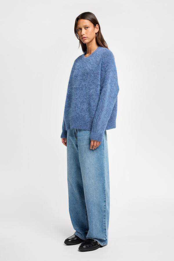 Front angle view of Model wearing alpaca blend Laurel Crew Neck Knit Sweater in indigo marle