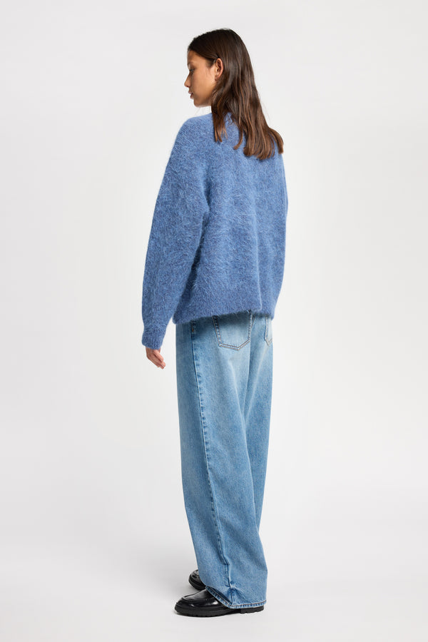 Back angle view of Model wearing alpaca blend Laurel Crew Neck Knit Sweater in indigo marle