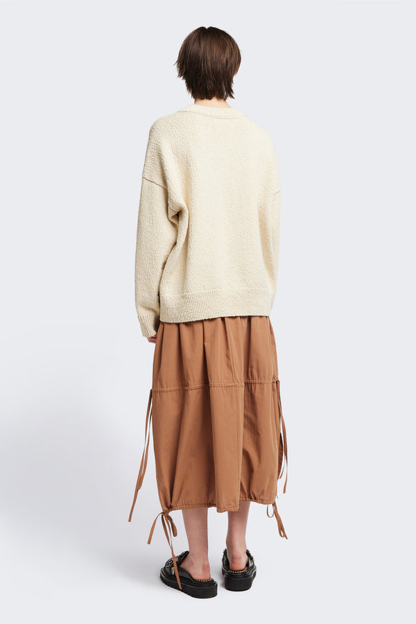 Back of the Ecru Leeway Sweater in a soft chunky cotton knit, featuring an oversized relaxed fit, raglan sleeves, and ribbed hem and cuffs.