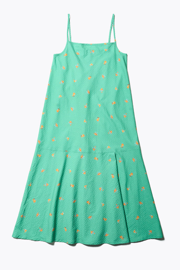 Flat Front of The Natant Dress in green floral, a Maxi-length Natant Dress with adjustable thin straps, a straight neckline, and a bias-cut silhouette, made from lightweight printed seersucker. Available in 5 sizes.