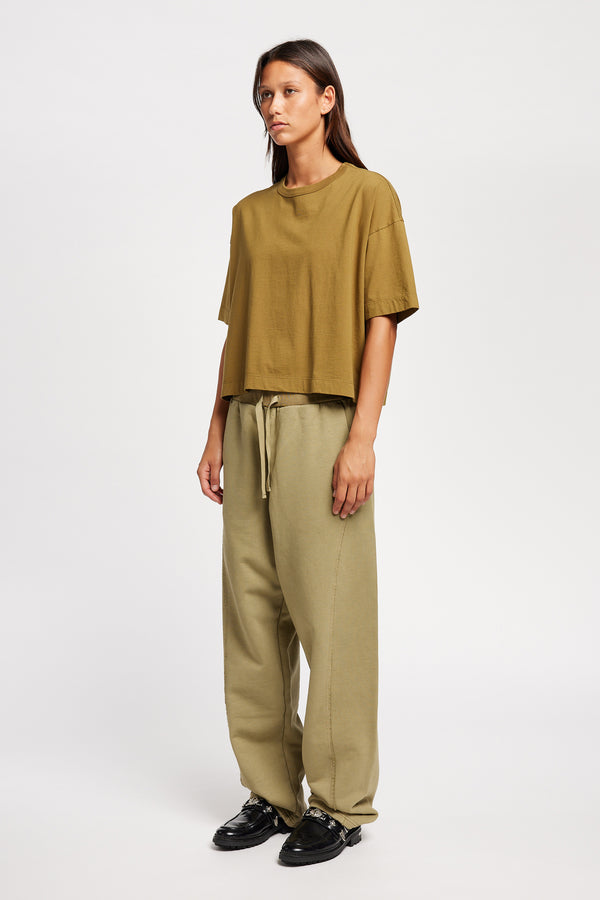 Model wearing Obelisk Tee in Olive Oil, showcasing oversized silhouette and dropped shoulders
