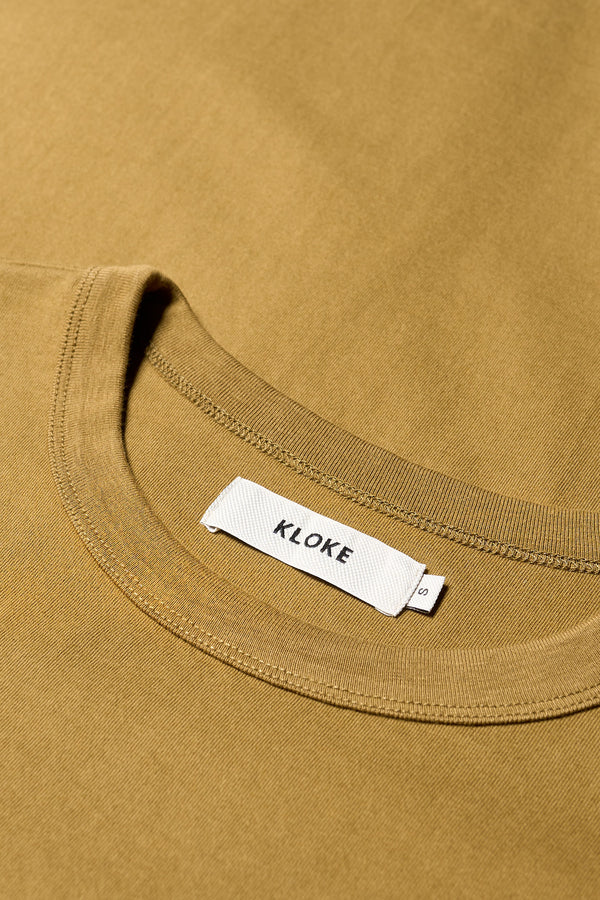 Close-up of 100% organic cotton fabric used in the Olive Oil Obelisk Tee