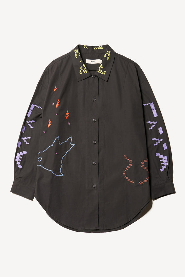 Flat front of Black One World Shirt with embroidered Arecibo motifs on collar, sleeves, and front. Classic collar and full placket.
