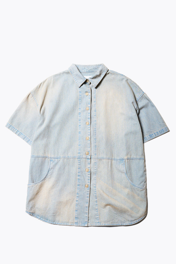 Flat Front of the Province Oversized short-sleeve denim shirt with feature front scoop pockets, in a blue fade with a slight pink tint. Available in 5 sizes.