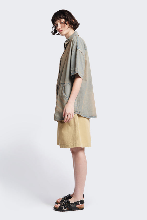 Side of the Province Oversized short-sleeve denim shirt with feature front scoop pockets, in a blue fade with a slight pink tint. Available in 5 sizes.