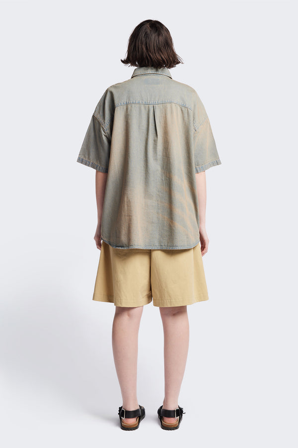 Back of the Province Oversized short-sleeve denim shirt with feature front scoop pockets, in a blue fade with a slight pink tint. Available in 5 sizes.
