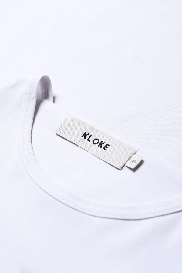 Close up fabric details of the Ride Short Sleeve top in Ice Blue. A crew neck jersey top in Japanese cotton stretch with cap sleeves.