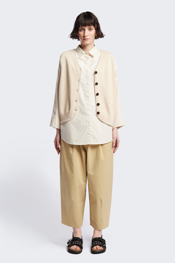 The Ritual Vest in Ecru Beige soft cotton rib, featuring a shallow V-neckline and centre front button placket. A versatile trans-seasonal layering piece, available in 5 sizes.