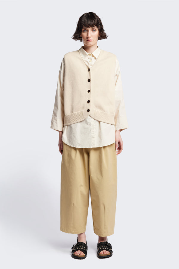 The Ritual Vest in Ecru Beige soft cotton rib, featuring a shallow V-neckline and centre front button placket. A versatile trans-seasonal layering piece, available in 5 sizes.
