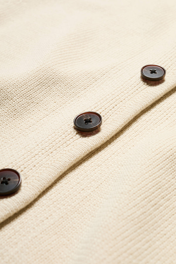 Close up fabric shot of The Ritual Vest in Ecru Beige soft cotton rib, featuring a shallow V-neckline and centre front button placket. A versatile trans-seasonal layering piece, available in 5 sizes.