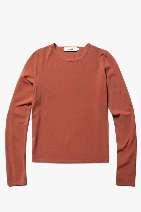 Flat Front view of the Seclude long sleeve top in Brick. A Slim-fit crew neck top in soft cotton stretch, featuring an exposed bound seam curving across the back and sleeves.
