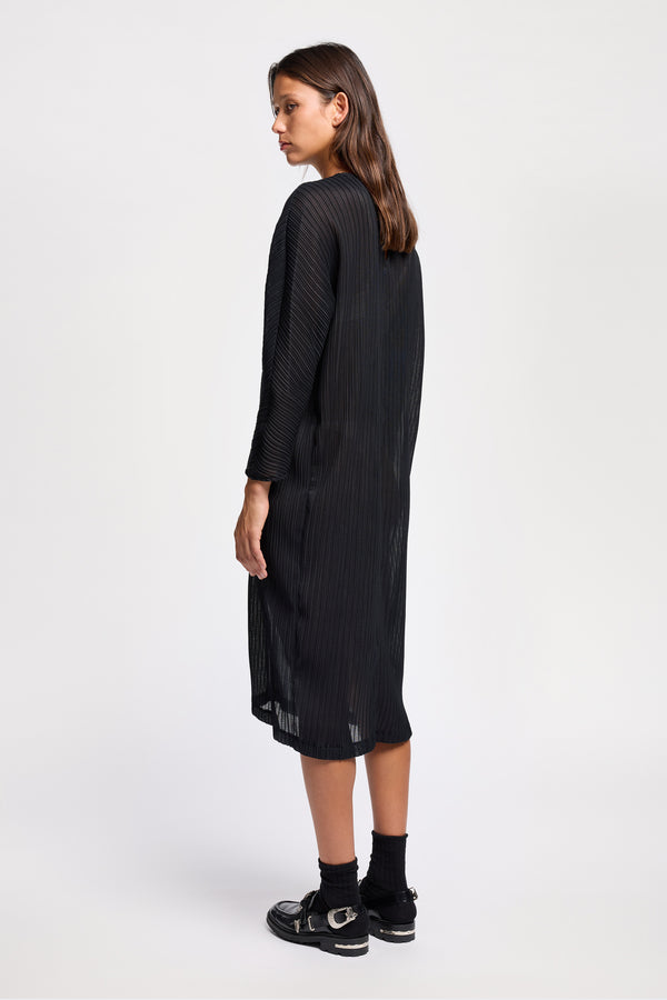 Back view of black Sequel Dress with high neckline, midi length, and bracelet sleeves