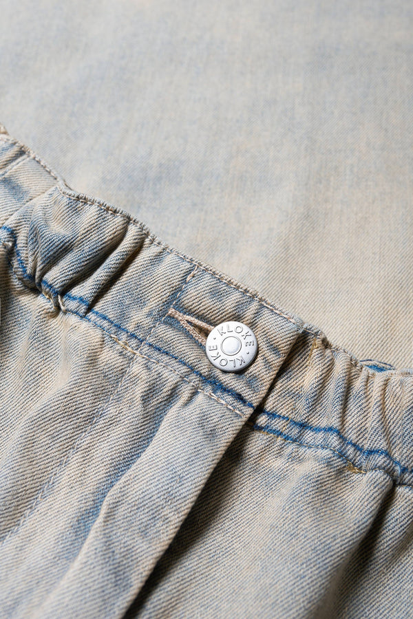 Close up of the Tunnel Denim Pant in Blue Pink Fade, with a relaxed fit, wide tapered leg, and elasticated waistband, made from lightweight Japanese cotton denim. Available in 5 sizes.