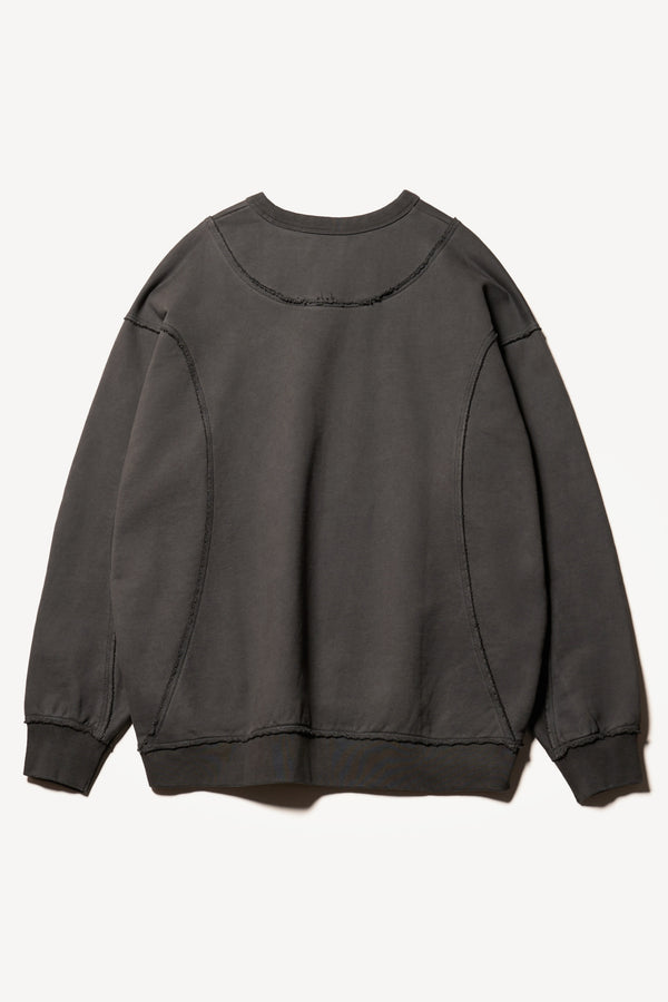 flat back of Unisex format oversized crew neck sweater in jet black with clean panelled design and raw flat-locked seams, displayed from the front.