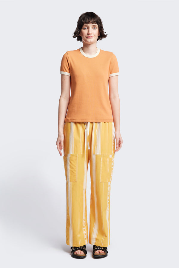 Front of the Veil Rib Tee a slim-fit ringer tee in pastel orange and ecru ribbed cotton, featuring a vintage 70's-inspired design with contrasting neckline and sleeve details. Available in 5 sizes.