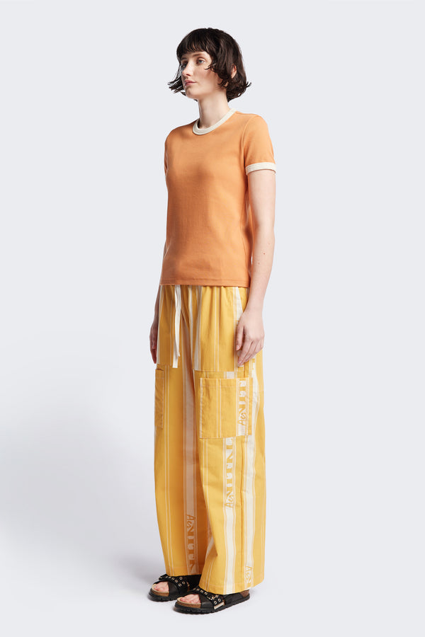 Front of the Veil Rib Tee a slim-fit ringer tee in pastel orange and ecru ribbed cotton, featuring a vintage 70's-inspired design with contrasting neckline and sleeve details. Available in 5 sizes.