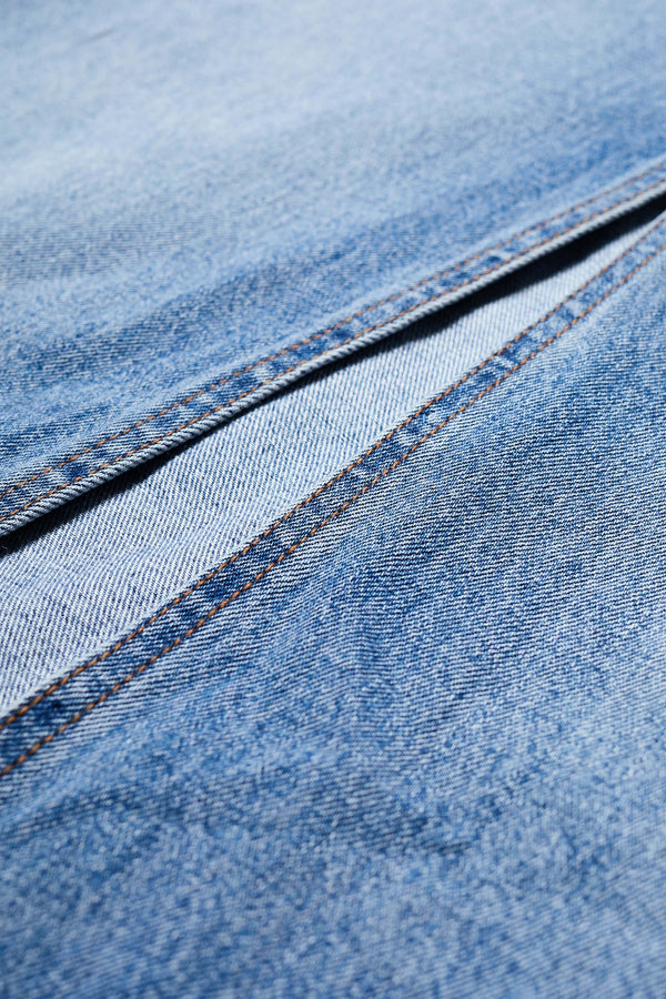 Close up of The Vivendi Skirt a Straight denim pencil skirt with a front split and midi length, crafted from 12oz Japanese denim. Available in 6 sizes.