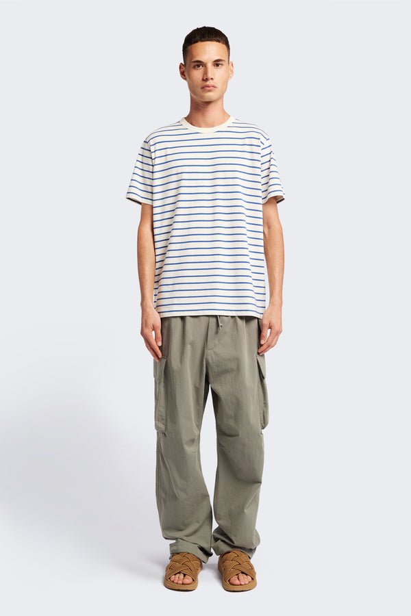 The Radius T-Shirt is a traditional tee with 1 x 1 rib-bound cover-stitched neckline that's reinforced at the back. Made from 100% organic cotton in blue and white stripe.