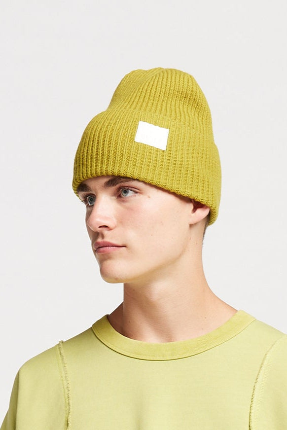 men - front view of model in olive oil Atoll merino beanie 