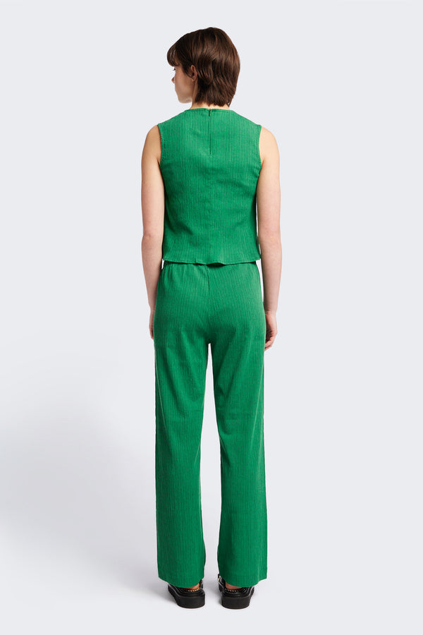 The back of the Aeon Crinkle Top in Green, featuring a sleeveless design, panelled bustline, high neckline, and concealed back zip. Crafted from structured crinkled crepe fabric. Available in 4 sizes.