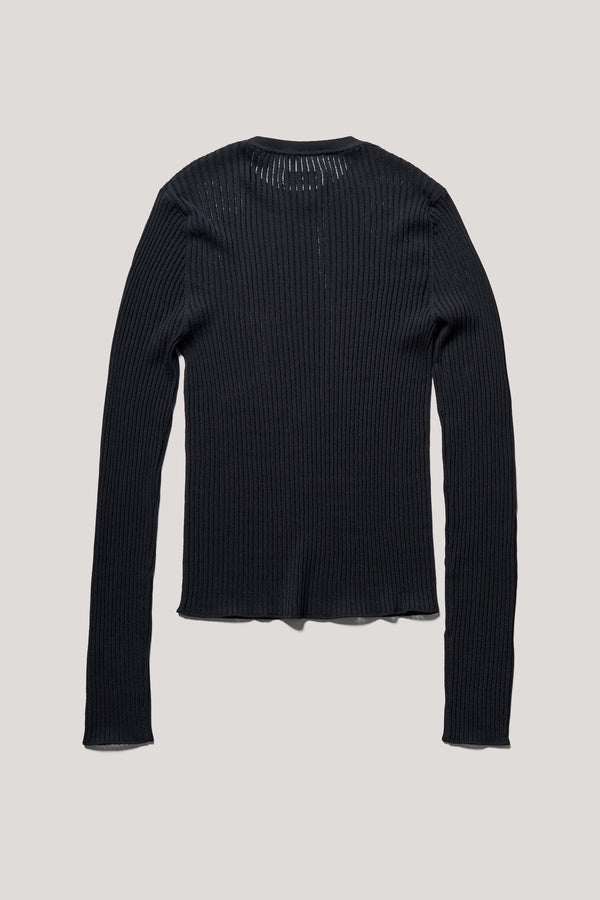 Flat back of the Black Verse Knit Tee with subtle drop-stitch texture and fitted long-sleeve silhouette.