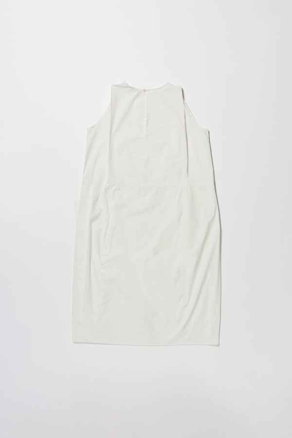 Flat back of the white  Aureole Dress front view showing panelled detailing and relaxed skirt with front inseam split