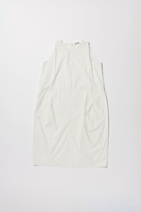 Flat front of the white  Aureole Dress front view showing panelled detailing and relaxed skirt with front inseam split