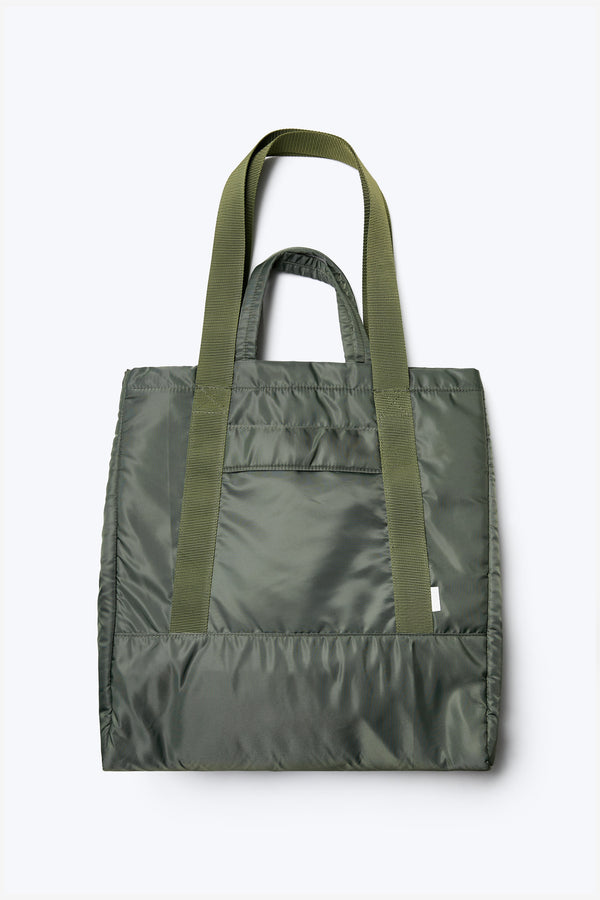 The Influx Padded Bag is made from tough technical nylon in olive green. It has four compartments, including two snap-closing pockets.