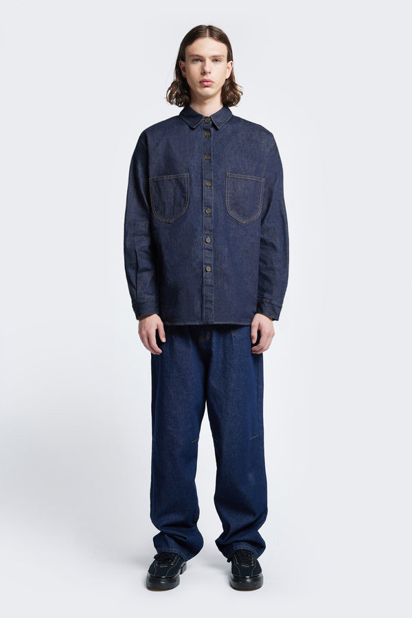 The Barium Denim Shirt cut from Japanese Denim with double scooped patch pockets, rounded hemline and long sleeves.