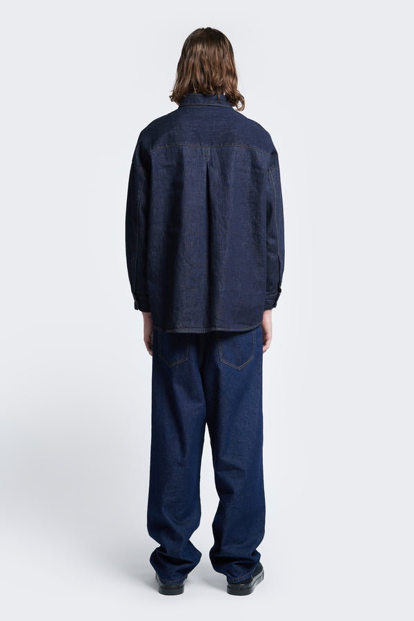The back of the Barium Denim Shirt Indigo with long sleeves and rounded hemline.