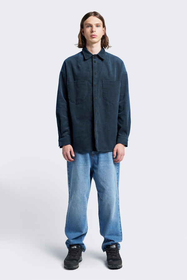 The front of the Corner Cord Shirt buttoned up and made from thick wale corduroy in Petrol Blue.