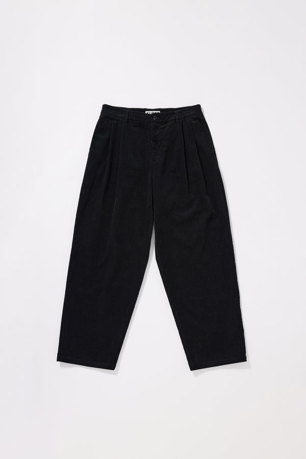 Flat front of black Dissolve Cord Pant showing loose double-pleated silhouette, button waistband with belt loops and garment double over-dyed corduroy