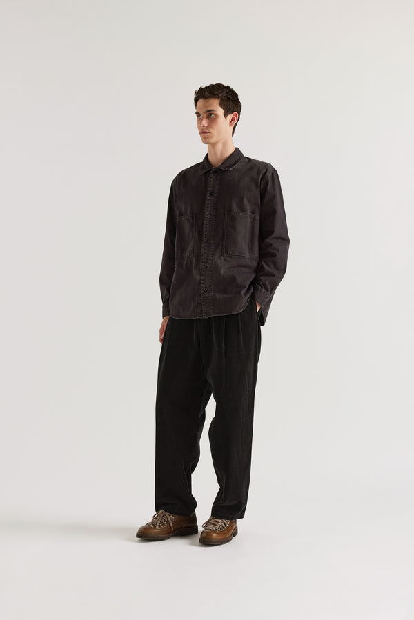 Vintage Black Dissolve Cord Pant front view on model showing loose double-pleated silhouette, button waistband with belt loops and garment double over-dyed corduroy