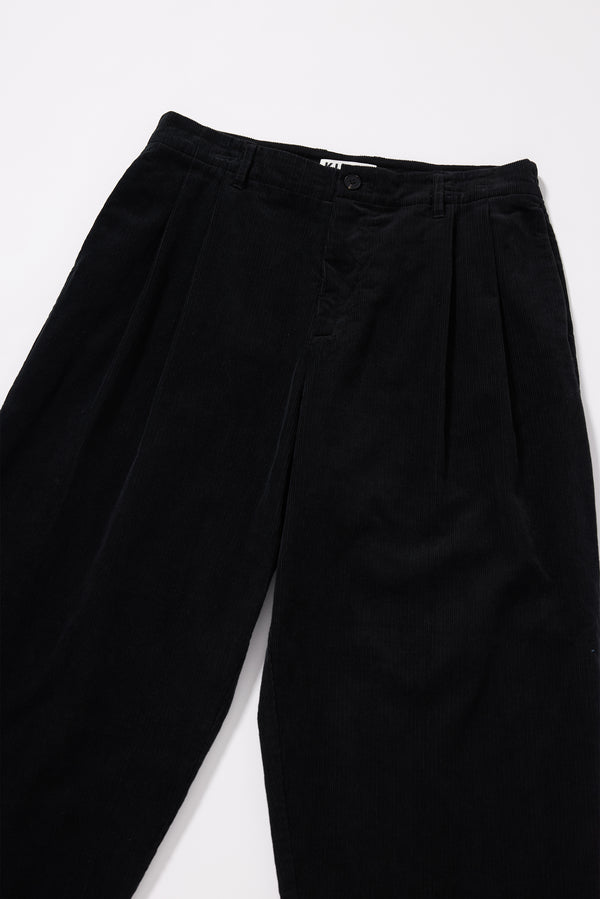 Close-up of corduroy texture on the black Dissolve Cord Pant showing deep rich colour achieved through garment double over-dye process
