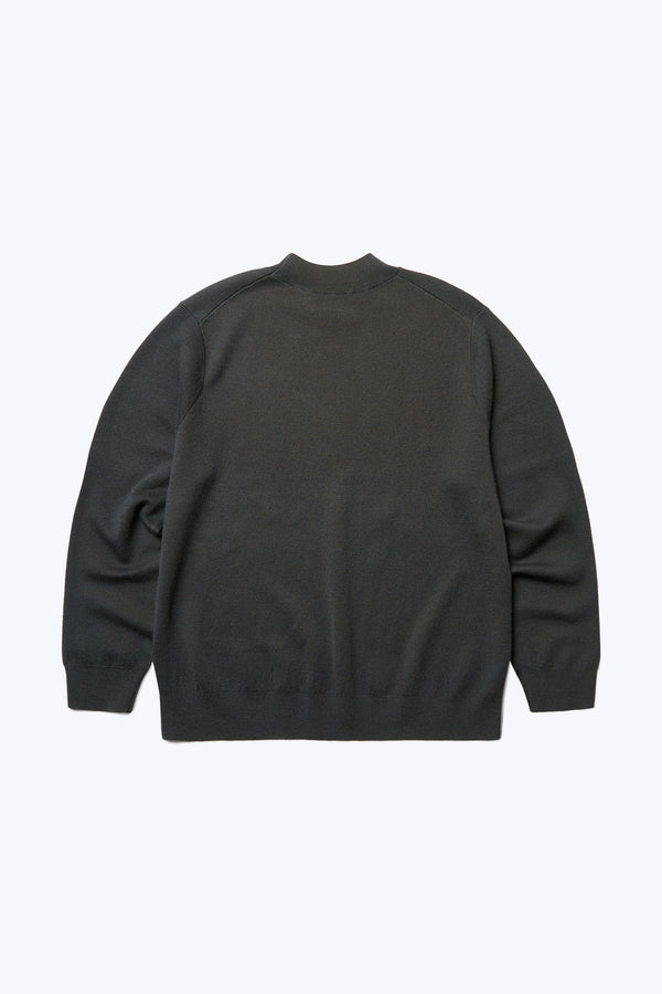 The back of the Dose Merino Sweater Charcoal made from 100% Merino. This mock-neck style is finished with a 1x1 rib hemline and cuffs and the Charcoal colour has deep hints of forest green. 