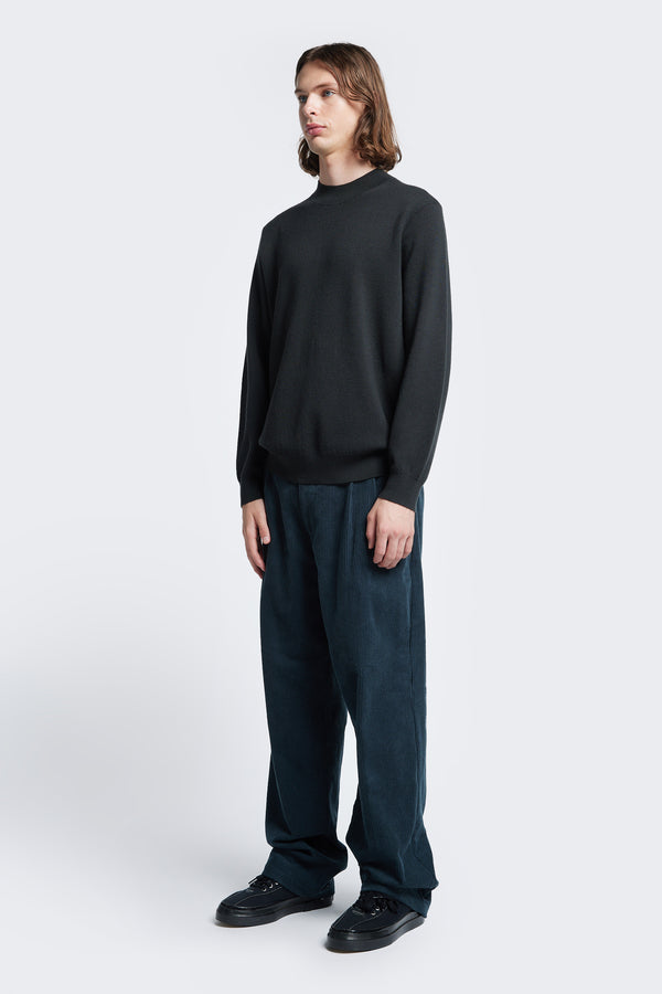 The Dose Merino Sweater Charcoal made from 100% Merino styled with Intake Cord Pant Petrol Blue.