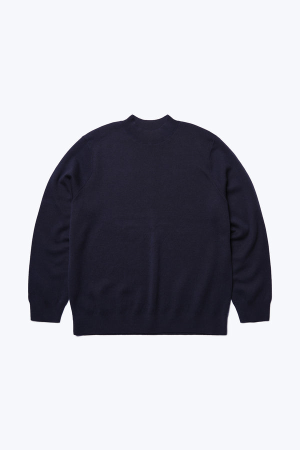 Flat lay of the front of the Dose Merino Sweater Ink, knitted in a fine Merino wool in a milano knit construction, this mock-neck style is finished with a 1x1 rib hemline and cuffs.