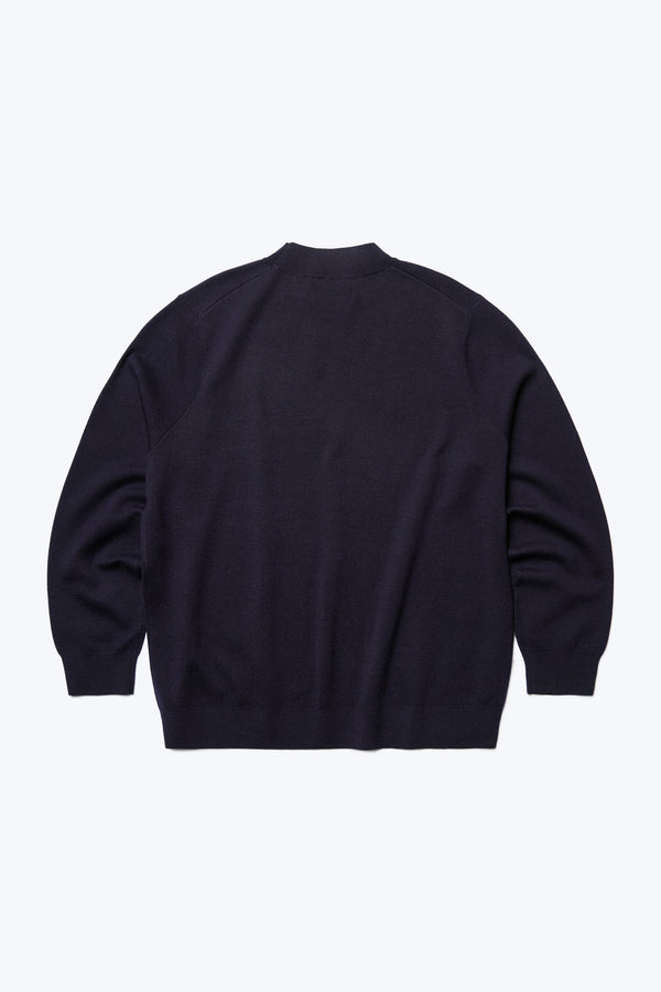 Flat lay of the back of the Dose Merino Sweater Ink made from 100% Merino. This mock-neck style is finished with a 1x1 rib hemline and cuffs.