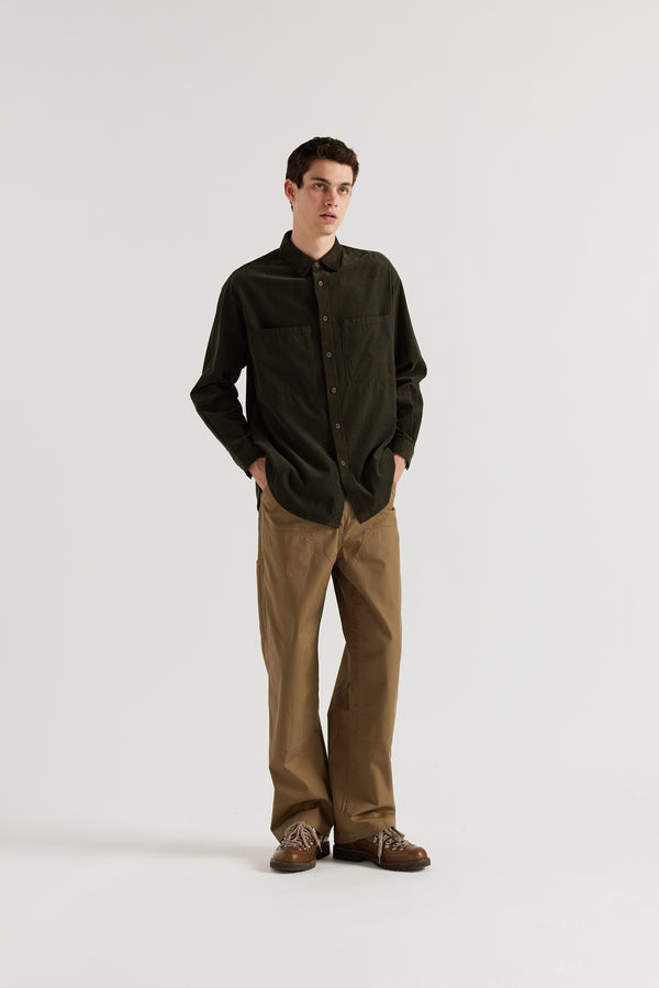 Brown Equinox Cord Shirt worn buttoned, showing relaxed silhouette, oversized front patch pockets and centre-front button placket in double over-dyed cotton corduroy
