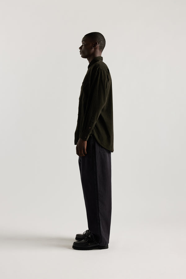 Side profile of the Ethereal Jean in black fade showing the relaxed straight-leg silhouette and forward seam detail.