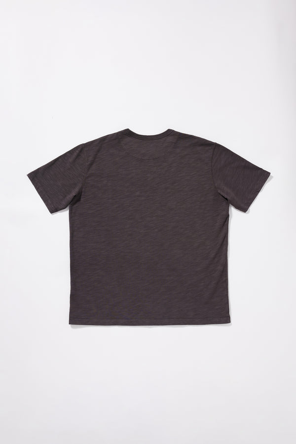 Flat Back view of the Inverse Tee showing the oversized silhouette and reinforced back neck yoke.