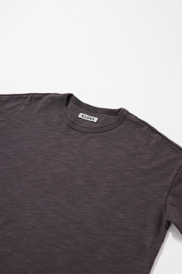 Close-up of the pigment-dyed slub cotton fabric showing its textured surface and soft finish.