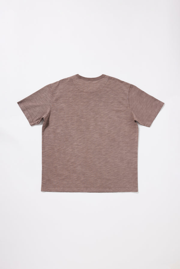 Flat Back view of the Inverse Tee showing the oversized silhouette and reinforced back neck yoke.