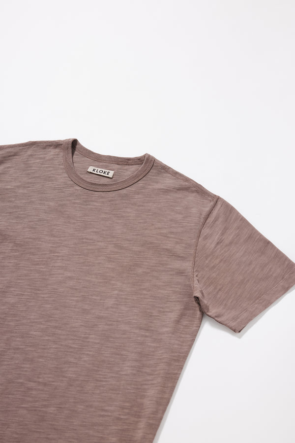 Close-up of the pigment-dyed slub cotton fabric showing its textured surface and soft finish.