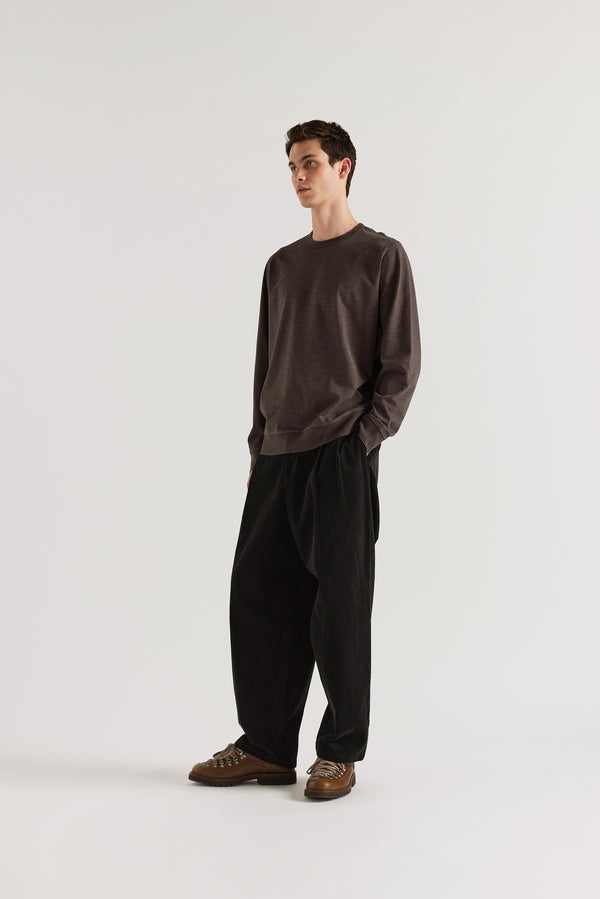 Front angle of model in the washed black/ licorice relaxed long-sleeve slub cotton T-shirt showing the easy fit.